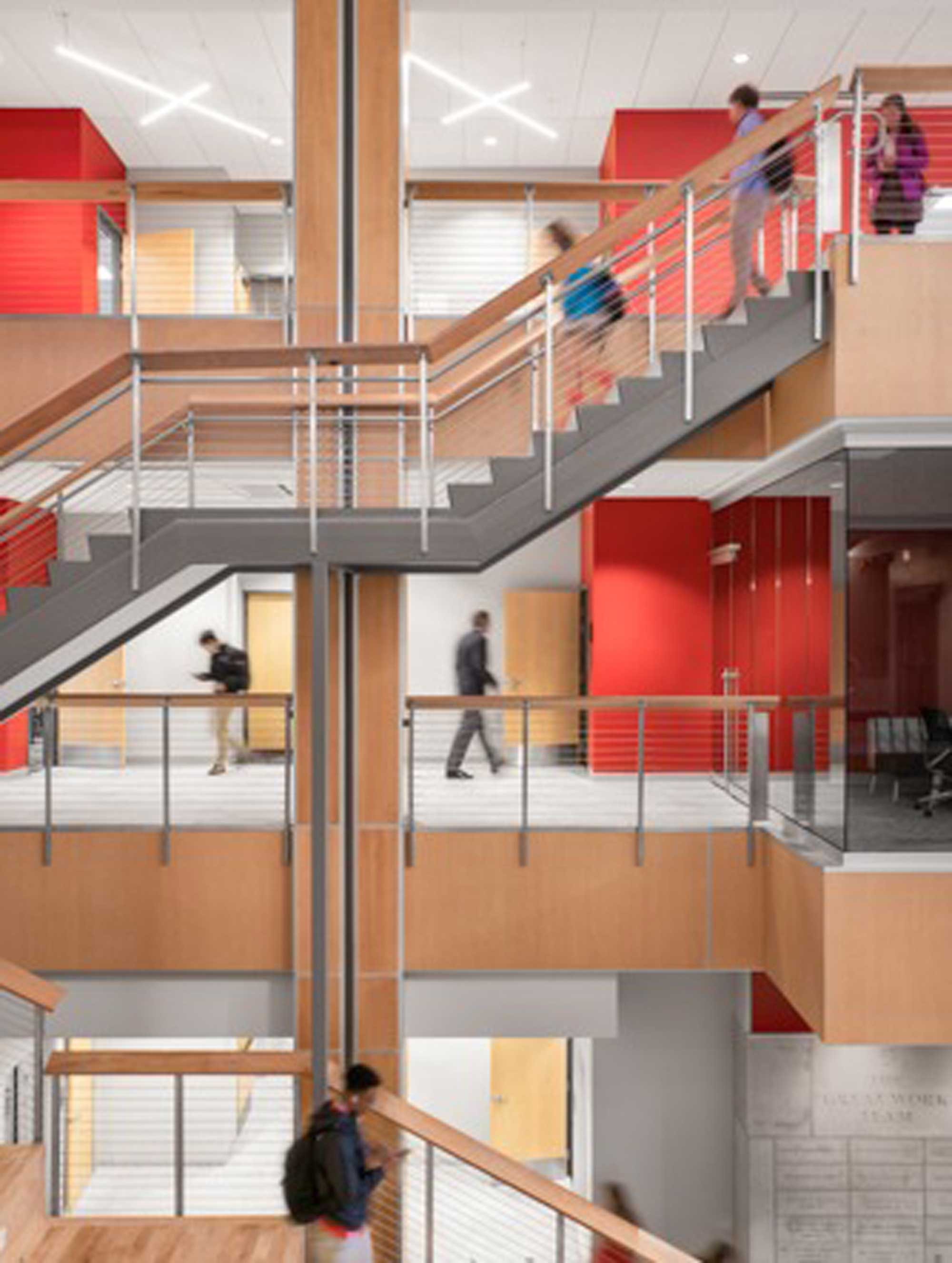 Multi-level stair tower with wood column and red accents